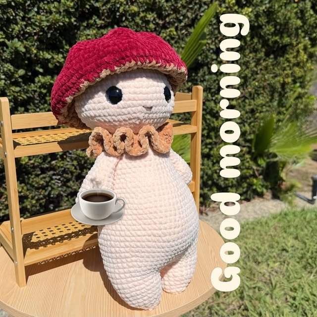 Handmade crochet doll wearing a red beret